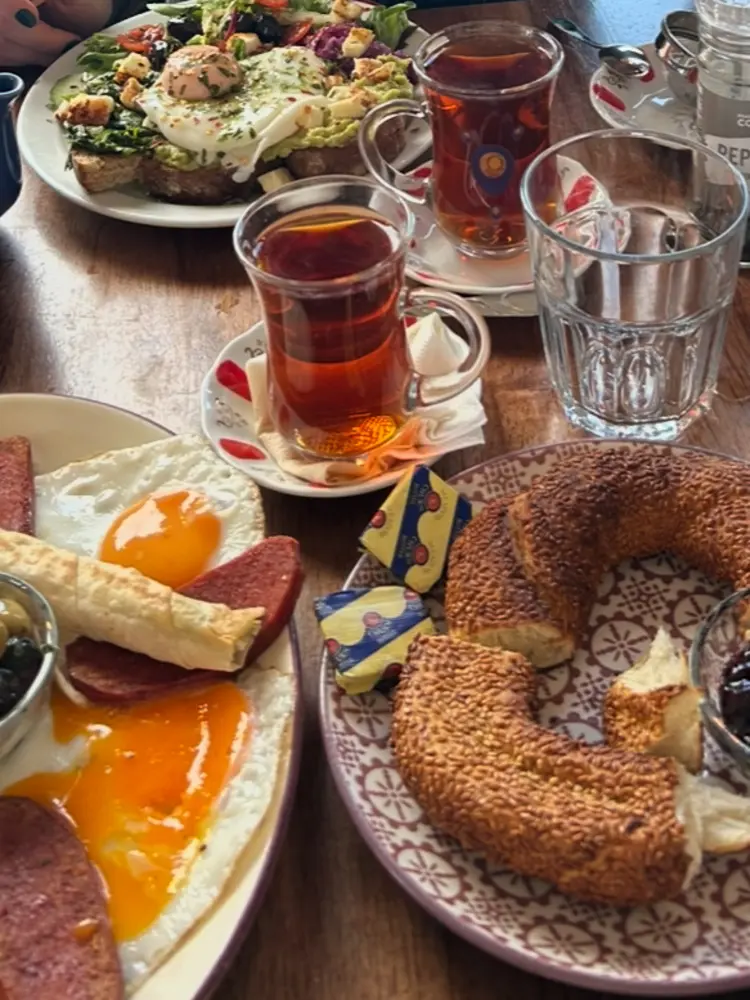 Turkish tea in tulip glasses with simit and fried eggs